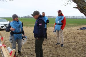 Photo 1. TPM Project Manager Mihail Semionov (right) and DRC Demining Team Lead Nadiia Vivdenko (left) at the task site with colleagues from the DRC. (© iMMAP Inc. Ukraine)  